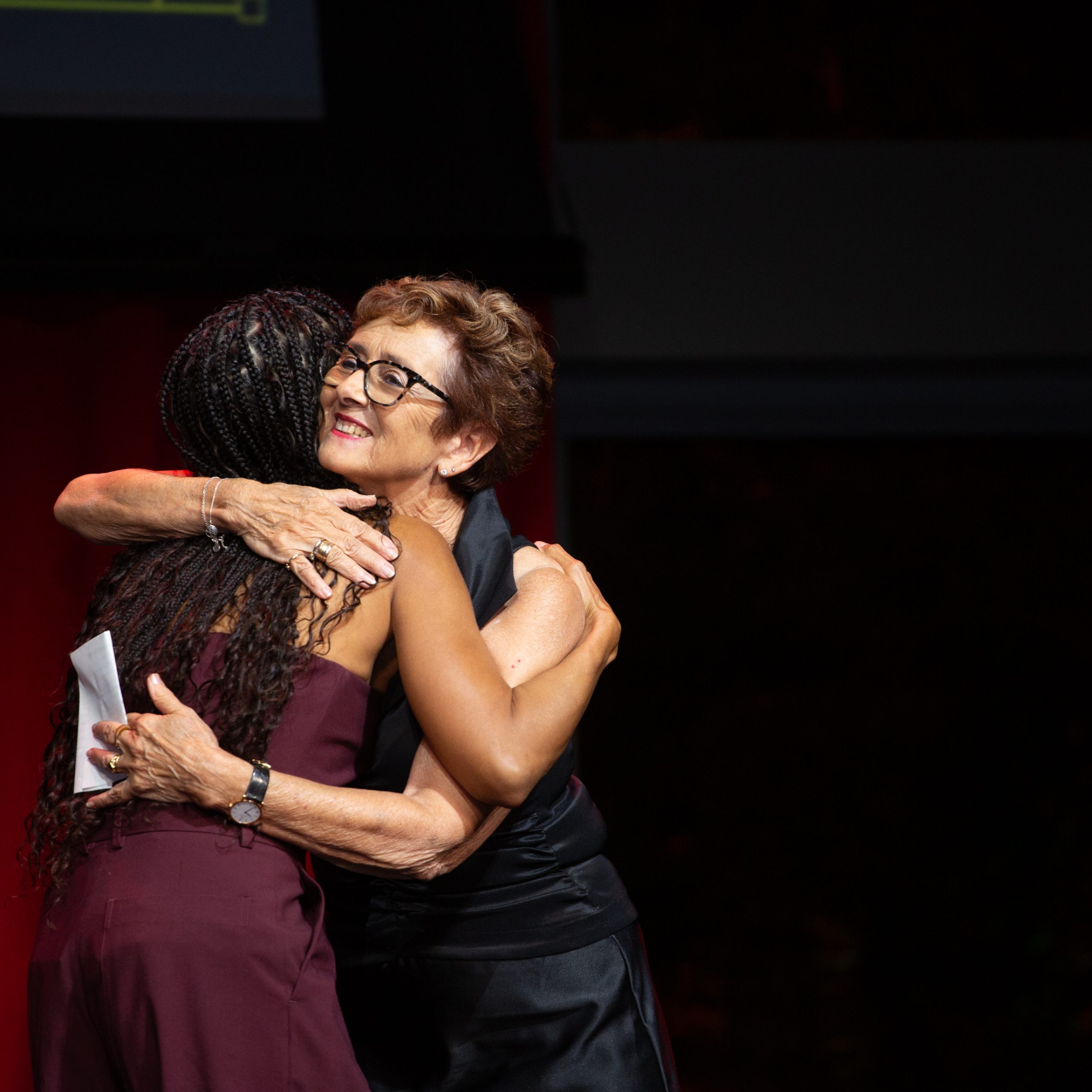 Judi Levine and Lauren Ridloff embrace on stage